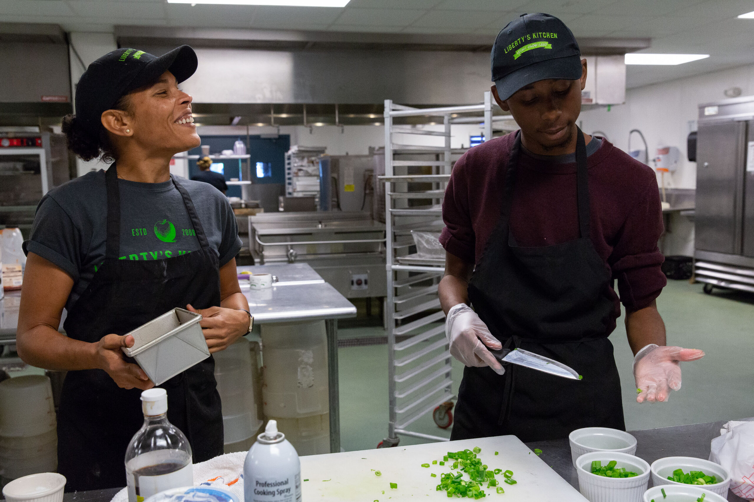 young black chefs from liberty's kitchen cooking together chopping limes