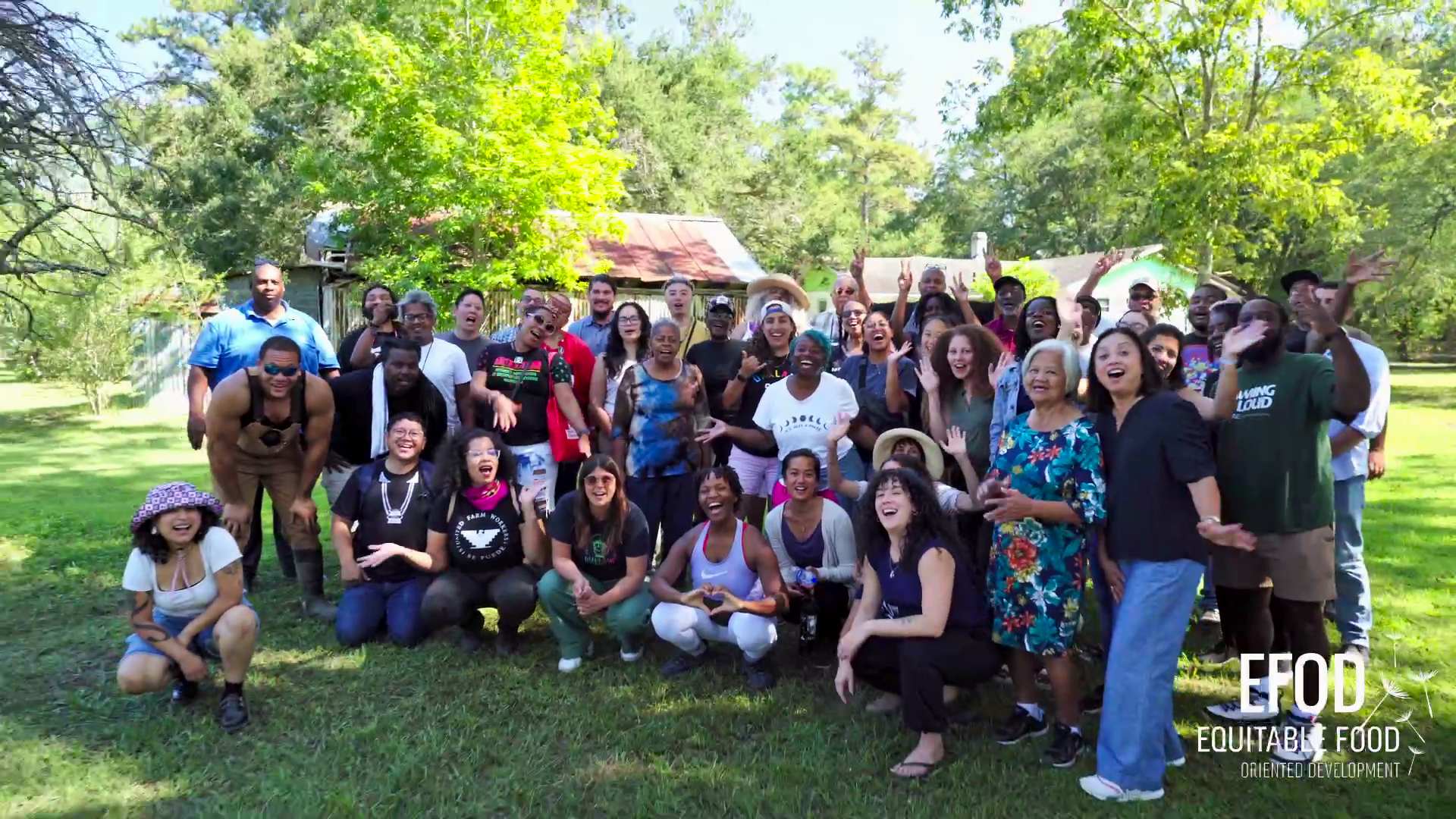 large group of smiling multiracial members of equitable food oriented development on an organic farm